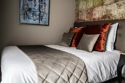 Un ou plusieurs lits dans un hébergement de l'établissement Les Chambres de Louise