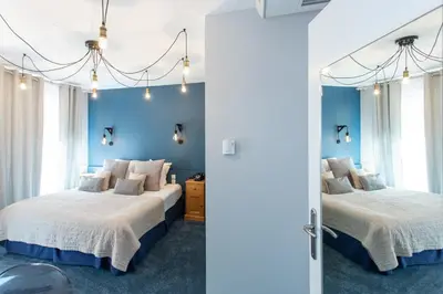 Un ou plusieurs lits dans un hébergement de l'établissement Hôtel Le Rapp