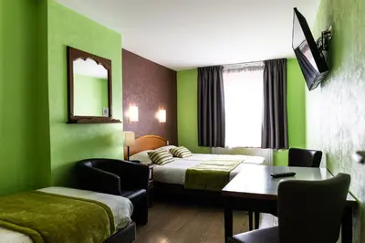 Un ou plusieurs lits dans un hébergement de l'établissement Hotel Cheval De Bronze