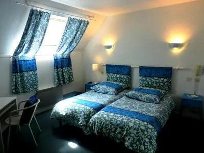 Un ou plusieurs lits dans un hébergement de l'établissement Hotel Restaurant Aux Sapins