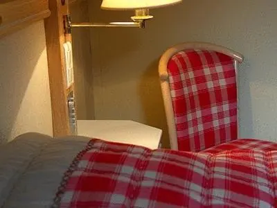 Un ou plusieurs lits dans un hébergement de l'établissement Hotel Les Remparts