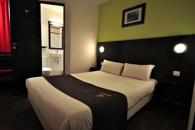 Un ou plusieurs lits dans un hébergement de l'établissement Enzo Hotel Mulhouse Sud Morschwiller le Bas