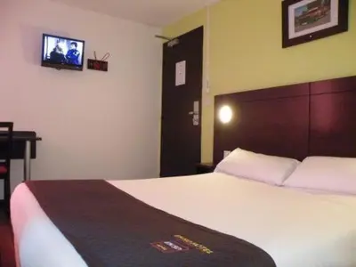 Un ou plusieurs lits dans un hébergement de l'établissement Enzo Hotel Mulhouse Sud Morschwiller le Bas