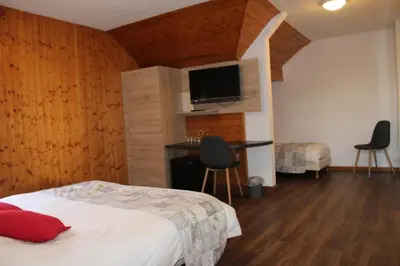 Un ou plusieurs lits dans un hébergement de l'établissement Hotel Restaurant Du Haut Du Roc