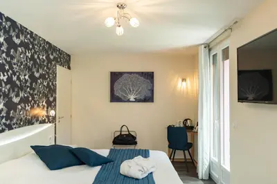 Un ou plusieurs lits dans un hébergement de l'établissement Logis Hotel Des Vosges