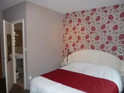 Un ou plusieurs lits dans un hébergement de l'établissement Logis Hotel Des Vosges