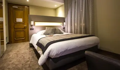 Un ou plusieurs lits dans un hébergement de l'établissement Hotel Au Nid De Cigognes
