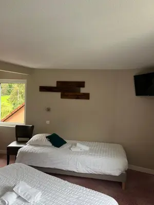 Un ou plusieurs lits dans un hébergement de l'établissement Hôtel Restaurant Valneige