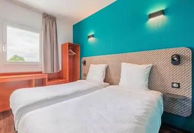 Un ou plusieurs lits dans un hébergement de l'établissement B&B HOTEL Mulhouse Kingersheim