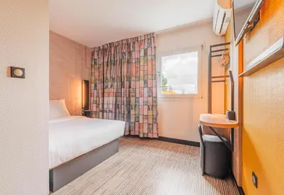 Un ou plusieurs lits dans un hébergement de l'établissement B&B HOTEL Mulhouse Sausheim
