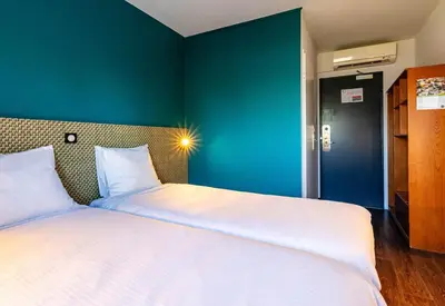 Un ou plusieurs lits dans un hébergement de l'établissement B&B HOTEL Colmar Lumière