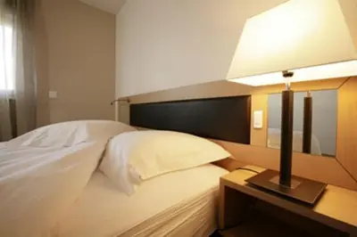 Un ou plusieurs lits dans un hébergement de l'établissement Hotel Résidence La Gioia