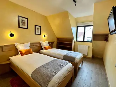 Un ou plusieurs lits dans un hébergement de l'établissement Les Chambres Du Vignoble