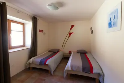 Un ou plusieurs lits dans un hébergement de l'établissement Gîte La Grange