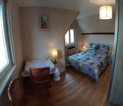 Un ou plusieurs lits dans un hébergement de l'établissement LA MAISON FLEURIE Gîtes du Florimont
