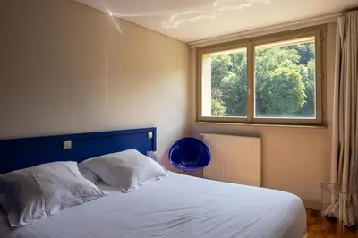 Un ou plusieurs lits dans un hébergement de l'établissement Hotel Du Lac