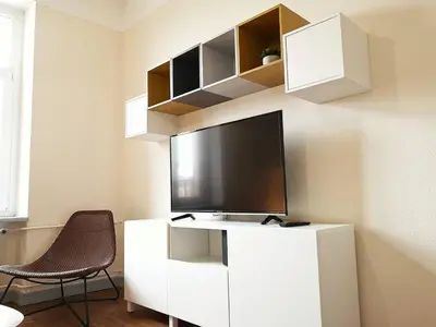 Télévision ou salle de divertissement dans l'établissement Le XI - Suite Colmar Gare