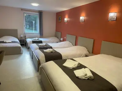 Un ou plusieurs lits dans un hébergement de l'établissement Hôtel du Ô des Bluches