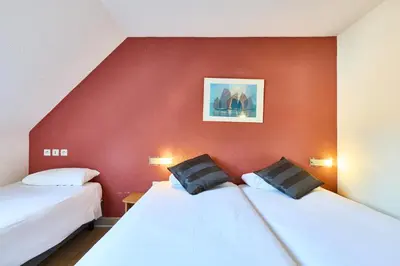 Un ou plusieurs lits dans un hébergement de l'établissement Cit'Hotel Primo Colmar Centre