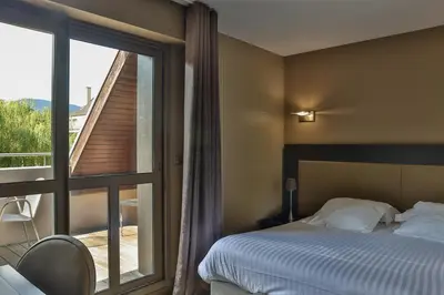 Un ou plusieurs lits dans un hébergement de l'établissement Hôtel Les Rives