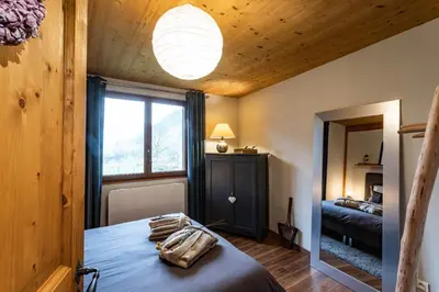 Un ou plusieurs lits dans un hébergement de l'établissement Chalet Les Myrtilles - Nature Randonnées Vélo