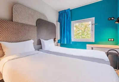 Un ou plusieurs lits dans un hébergement de l'établissement B&B HOTEL Mulhouse Dornach