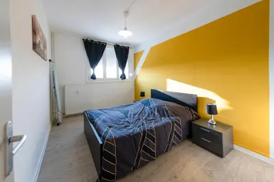 Un ou plusieurs lits dans un hébergement de l'établissement Appart'Hôtel - l'île en mouvement