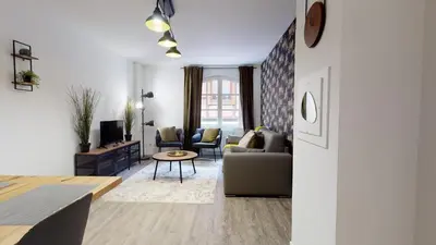 Coin salon dans l'établissement Appartement 2 chambres La Commanderie