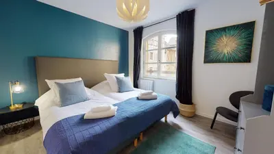 Un ou plusieurs lits dans un hébergement de l'établissement Appartement 2 chambres La Commanderie