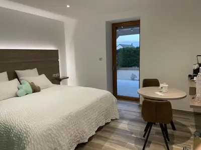 Un ou plusieurs lits dans un hébergement de l'établissement Les chambres d'à côté