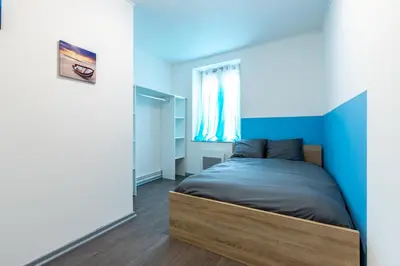 Un ou plusieurs lits dans un hébergement de l'établissement Appart'hotel de la Roseraie