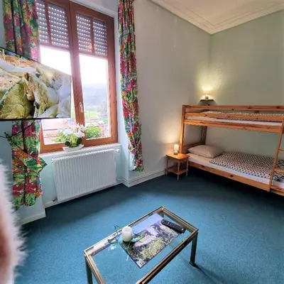 Un ou plusieurs lits dans un hébergement de l'établissement Gite Fougère 2 à 6 personnes avec SPA et salle de jeux dans la résidence