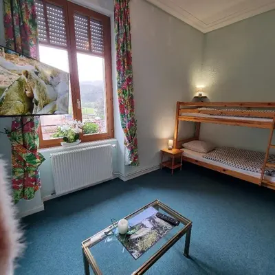 Un ou plusieurs lits dans un hébergement de l'établissement Gite Fougère 2 à 6 personnes avec SPA et salle de jeux dans la résidence