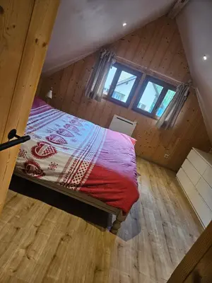 Un ou plusieurs lits dans un hébergement de l'établissement Le chalet du bois joli
