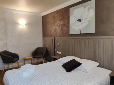 Un ou plusieurs lits dans un hébergement de l'établissement Hôtel Influences La Bresse