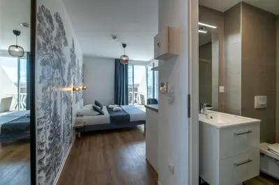 Un ou plusieurs lits dans un hébergement de l'établissement Lagrange Apart Hôtel Mulhouse Saint Sauveur