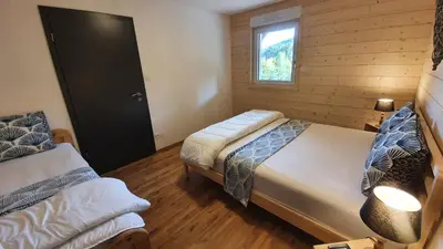 Un ou plusieurs lits dans un hébergement de l'établissement CHALET LES PRIMEVÈRES 4 Étoiles