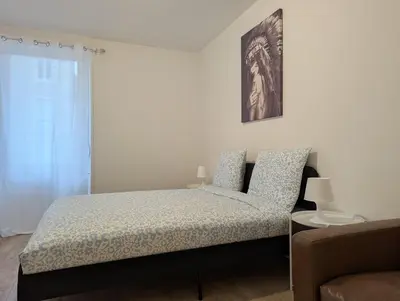 Un ou plusieurs lits dans un hébergement de l'établissement Le Vauban - appartement 2 chambres, salon, cuisine équipée, parking et wifi gratuit